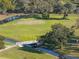 Scenic aerial view of the community golf course, surrounded by lush greenery and landscaping at 36806 Niles Dr, Zephyrhills, FL 33542