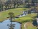 Scenic golf course view with winding water features, mature trees, and meticulously maintained greens at 36806 Niles Dr, Zephyrhills, FL 33542