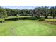 Aerial view of a well-maintained green area with a pond nearby at 36806 Niles Dr, Zephyrhills, FL 33542