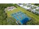 Aerial view of the community tennis courts, surrounded by lush greenery and landscaping at 36806 Niles Dr, Zephyrhills, FL 33542