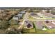 Aerial view of a neighborhood street with multiple homes featuring solar panels at 38205 Countryside Pl, Dade City, FL 33525