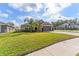 Single Gathering house with a front lawn and a palm tree in the front yard at 38205 Countryside Pl, Dade City, FL 33525