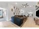 Bright living room with tile flooring, a ceiling fan, and access to the kitchen and front entrance at 38205 Countryside Pl, Dade City, FL 33525