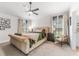 This main bedroom features natural lighting with a neutral color palette, a ceiling fan, and carpet at 38205 Countryside Pl, Dade City, FL 33525