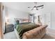 This cozy main bedroom features natural lighting, a ceiling fan, carpet, and neutral colors at 38205 Countryside Pl, Dade City, FL 33525