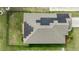 Aerial view of a house featuring solar panels on the roof and a well-maintained, fenced-in backyard at 38205 Countryside Pl, Dade City, FL 33525