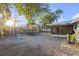 A view of the backyard with trampoline, barbeque, and home at 4077 Ramona Dr, Spring Hill, FL 34606