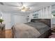 Bright bedroom featuring wood-look floors, a ceiling fan, and a comfortable bed at 4077 Ramona Dr, Spring Hill, FL 34606