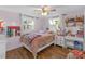 Adorable bedroom featuring hardwood floors, pink walls, and a lot of storage at 4077 Ramona Dr, Spring Hill, FL 34606