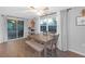 Dining area with slider door to patio, wood-look flooring, and light gray walls at 4077 Ramona Dr, Spring Hill, FL 34606