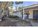 Home's front with a blue door, chairs, and landscape lighting at 4077 Ramona Dr, Spring Hill, FL 34606