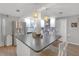 Kitchen island with countertop seating and stainless refrigerator at 4077 Ramona Dr, Spring Hill, FL 34606