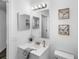 Well-lit bathroom with modern fixtures, decorative mirrors, and a fresh, clean aesthetic at 4306 Goldcoast Ave, Spring Hill, FL 34609