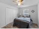 Comfortable bedroom featuring closet, wood-look flooring, and neutral decor, creating a relaxing space at 4306 Goldcoast Ave, Spring Hill, FL 34609