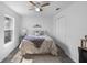 Cozy bedroom with a ceiling fan, neutral decor, and ample natural light at 4306 Goldcoast Ave, Spring Hill, FL 34609