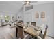 Bright dining area with a wood table, wicker chairs, and an open view to the living room at 4306 Goldcoast Ave, Spring Hill, FL 34609