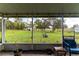 View of a spacious backyard from a screened-in porch with string lights and a sitting area at 5106 Tanner Rd, Spring Hill, FL 34609