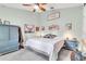 A charming bedroom with light green walls, rustic decor, and comfortable furnishings at 5106 Tanner Rd, Spring Hill, FL 34609