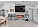 Living room featuring a large television mounted above a modern electric fireplace at 5106 Tanner Rd, Spring Hill, FL 34609