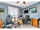 Home office featuring blue walls, a desk with multiple monitors, and comfortable chairs at 5106 Tanner Rd, Spring Hill, FL 34609