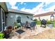 Outdoor patio area with a dining table, chairs, a grill, and decorative plants at 5106 Tanner Rd, Spring Hill, FL 34609