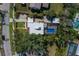 Aerial of home with pool, surrounded by lush landscaping, and charming street at 610 Casabella Dr, Bradenton, FL 34209