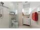 Modern bathroom featuring glass shower, a white vanity, and neutral tile at 610 Casabella Dr, Bradenton, FL 34209