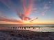 Beautiful sunset over water, with colorful clouds and birds on the beach at 610 Casabella Dr, Bradenton, FL 34209