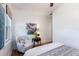 Bedroom featuring a decorative chair, stylish lighting, and neutral color palette at 610 Casabella Dr, Bradenton, FL 34209