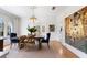 Bright dining area with rustic table, chandelier, and a neutral color palette at 610 Casabella Dr, Bradenton, FL 34209