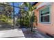 Outdoor shower surrounded by lush tropical landscaping, adjacent to the screened pool area at 610 Casabella Dr, Bradenton, FL 34209