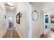 Bright hallway leads to rooms featuring wood floors and stylish decor at 610 Casabella Dr, Bradenton, FL 34209