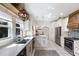 Bright kitchen features white cabinetry, stainless appliances, and a stylish light fixture above the island at 610 Casabella Dr, Bradenton, FL 34209