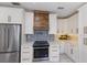 The kitchen features an oven and stove top with a wooden hood and patterned backsplash at 610 Casabella Dr, Bradenton, FL 34209