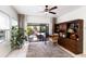 Bright office with a dark wood bookcase, desk, and sliding glass doors to a screened-in outdoor space at 610 Casabella Dr, Bradenton, FL 34209