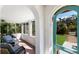 Bright sunroom with terra cotta tile, arched doorways, and comfortable seating at 610 Casabella Dr, Bradenton, FL 34209