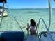 Girl enjoying shallow, clear ocean water, near boat at 610 Casabella Dr, Bradenton, FL 34209