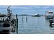 Waterfront scene with boats docked along the canal and a bird perched on the pier at 610 Casabella Dr, Bradenton, FL 34209