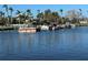 Scenic view of boats docked along a canal lined with palm trees on a sunny day at 610 Casabella Dr, Bradenton, FL 34209