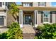 Inviting front entrance with decorative glass doors, stone walkway, and lush landscaping at 6326 Brevada Ln, Apollo Beach, FL 33572