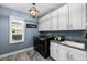 The laundry room features stainless steel washer and dryer, white cabinets, and a dark gray granite countertop at 6326 Brevada Ln, Apollo Beach, FL 33572