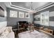 This is a home office with gray and white horizontal stripes, wood floors, and a desk with two monitors at 6326 Brevada Ln, Apollo Beach, FL 33572