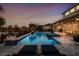 Beautiful evening shot of a custom backyard with a sparkling pool and spa at 6326 Brevada Ln, Apollo Beach, FL 33572