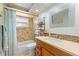 Bathroom featuring tiled shower and backsplash, and decorative mirror at 6518 Leeside Isle, Hudson, FL 34667