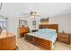 Spacious bedroom features a ceiling fan, wood flooring and a large decorative wood headboard at 6518 Leeside Isle, Hudson, FL 34667