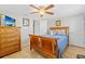 Bedroom featuring hardwood floors, ceiling fan and a TV at 6518 Leeside Isle, Hudson, FL 34667