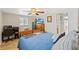 Bedroom with hardwood floors, ceiling fan, and a desk area at 6518 Leeside Isle, Hudson, FL 34667