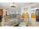 Charming dining area with wicker chairs and a brick accent wall in the background at 6518 Leeside Isle, Hudson, FL 34667