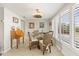 Bright dining area with wicker chairs and a view of the outdoors through shuttered windows at 6518 Leeside Isle, Hudson, FL 34667