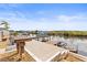 Waterfront property featuring a concrete dock with boat and jet ski lifts, perfect for water sports enthusiasts at 6518 Leeside Isle, Hudson, FL 34667